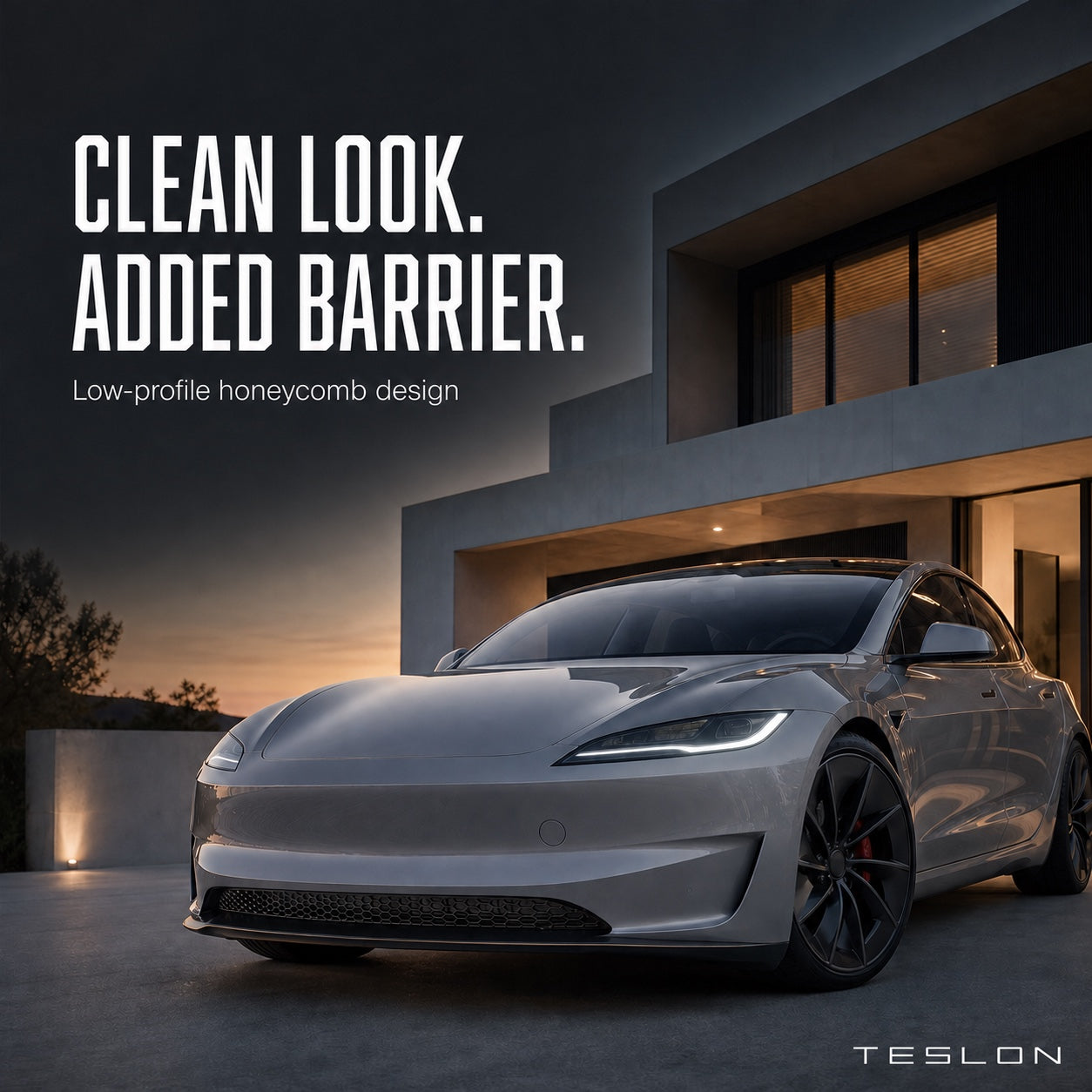 Low-profile black honeycomb guard installed in the lower intake of a gray electric sedan